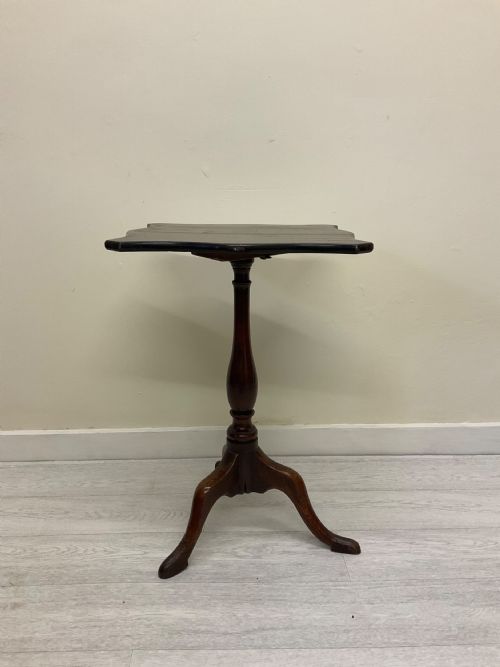fig 6. A dark mahogany Victorian tilt-top side table resting on a turned central pedestal with three cabriole legs, shown with the top secured in the vertical position.