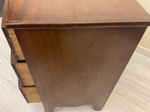 fig 3. A Victorian mahogany chest of drawers featuring three curved bow-front drawers, brass hardware, and shaped feet.