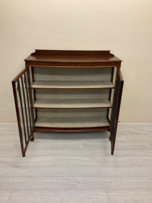 fig 1. An early 20th-century mahogany glazed display cabinet with decorative astragal glazing bars, cabriole legs, and ball-and-claw feet.