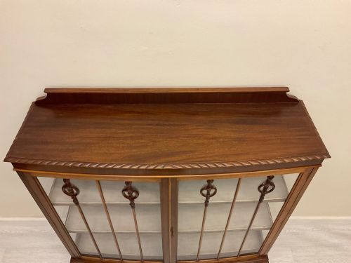 fig 3. An early 20th-century mahogany glazed display cabinet with decorative astragal glazing bars, cabriole legs, and ball-and-claw feet.