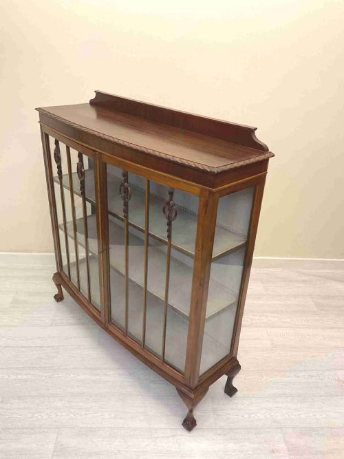 fig 4. An early 20th-century mahogany glazed display cabinet with decorative astragal glazing bars, cabriole legs, and ball-and-claw feet.