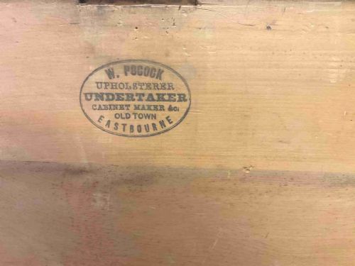 fig 6. A rectangular 19th-century Victorian pine trunk featuring a dark brown finish, hinged flat lid, central keyhole, and plinth base.