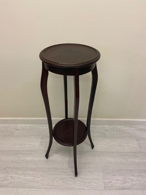 fig 4. A non-matching pair of dark brown mahogany plant stands featuring circular tops, lower undertiers, and curved legs.