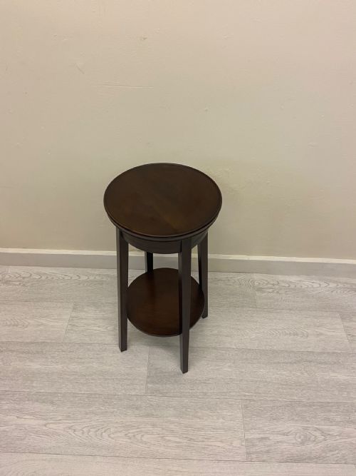 fig 5. A non-matching pair of dark brown mahogany plant stands featuring circular tops, lower undertiers, and curved legs.