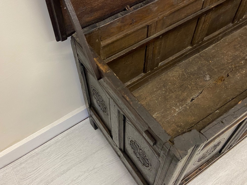 An 18th-century dark oak coffer with a flat rectangular top and four recessed front panels resting on extended stile feet. View VIII