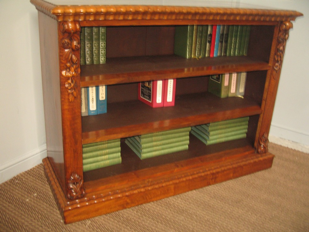 A Victorian open walnut bookcase featuring three shelves and carved floral corbels on side pilasters. View II