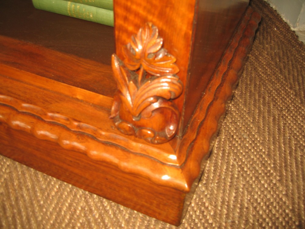 A Victorian open walnut bookcase featuring three shelves and carved floral corbels on side pilasters. View VI