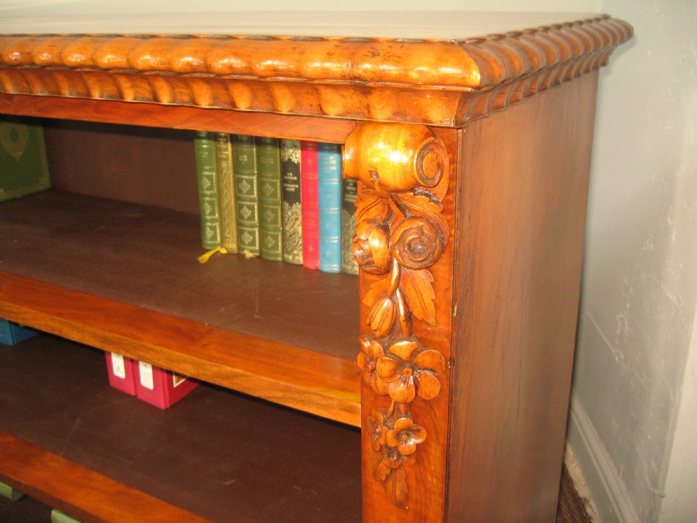 A Victorian open walnut bookcase featuring three shelves and carved floral corbels on side pilasters. View VII
