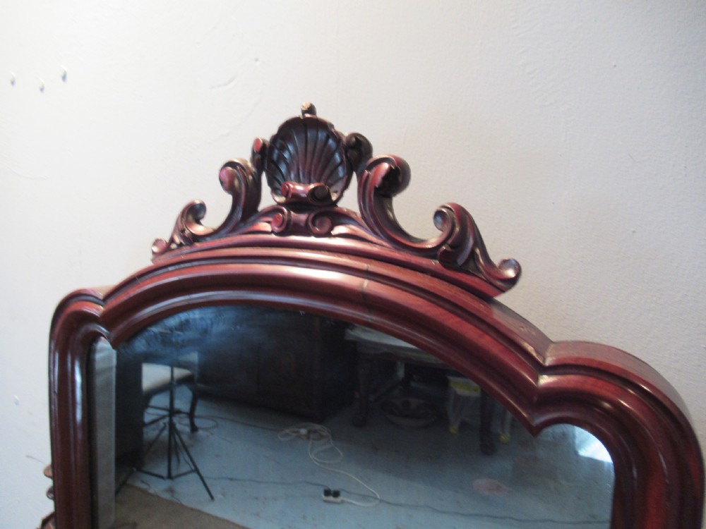 Victorian mahogany duchess dressing table featuring an arched swivel mirror, scroll supports, tier of trinket drawers, and a curved base with carved front legs. View VI