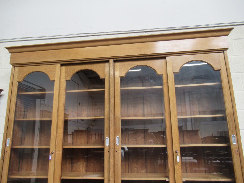 Large light oak bookcase  with sliding glass doors View II