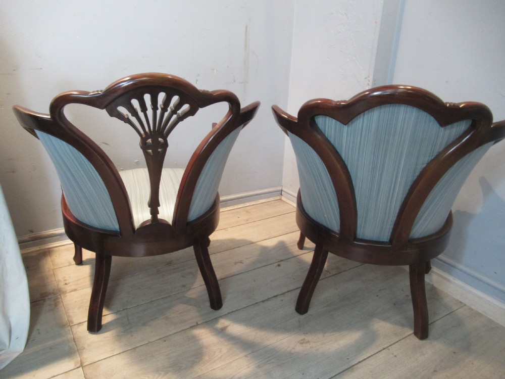 A similar  pair of Edwardian  mahogany arm chairs View V