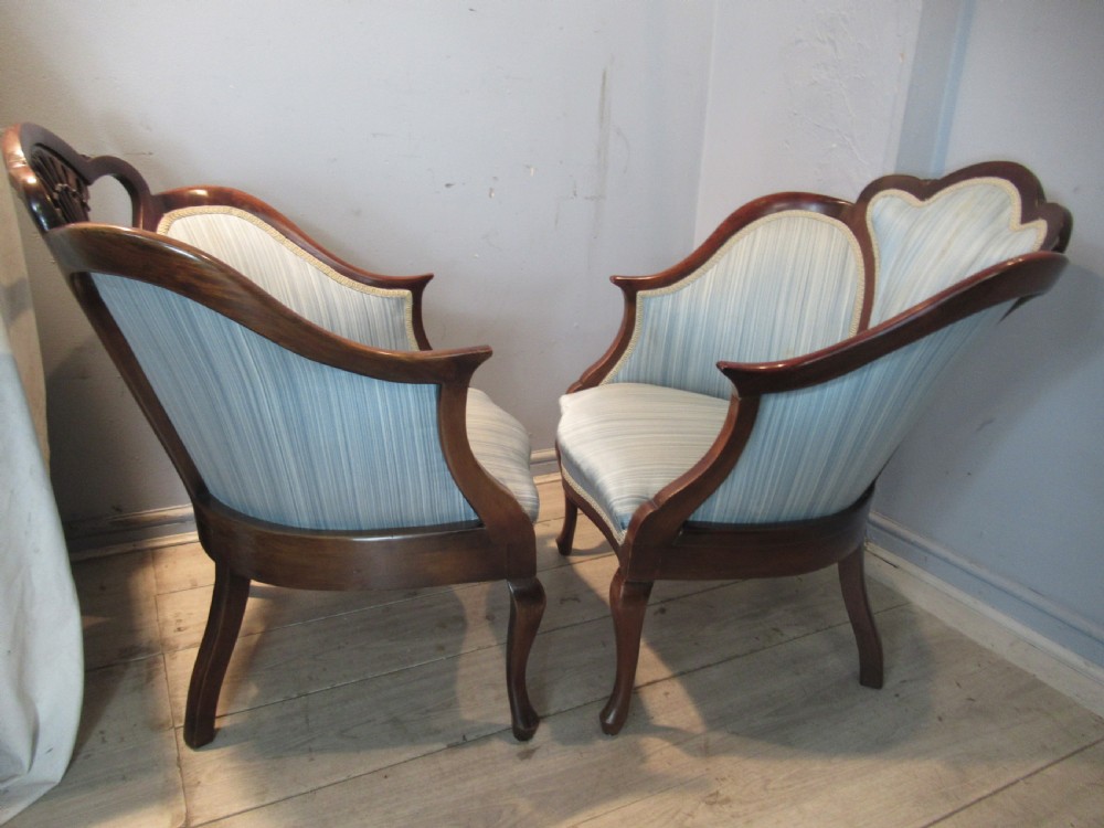 A similar  pair of Edwardian  mahogany arm chairs View VI