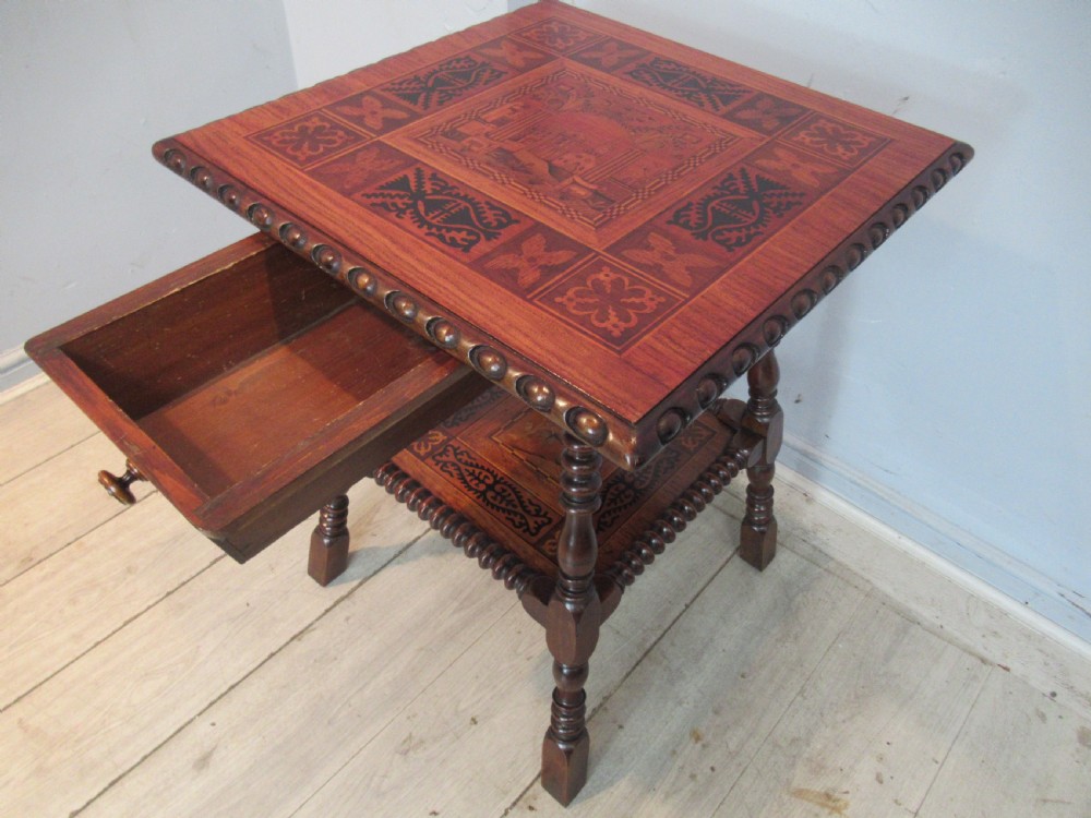 A 19th-century rich brown wood side table featuring a single drawer with marquetry inlay, carved bead edging, turned legs, and an inlaid lower shelf. View V