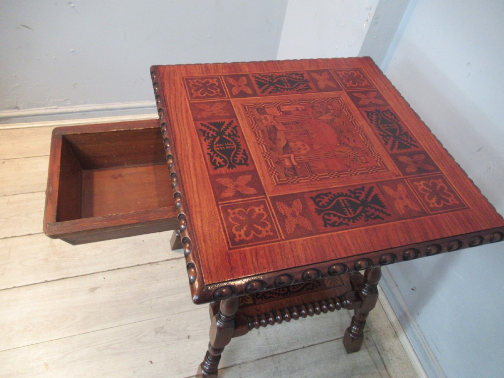A 19th-century rich brown wood side table featuring a single drawer with marquetry inlay, carved bead edging, turned legs, and an inlaid lower shelf. View VI