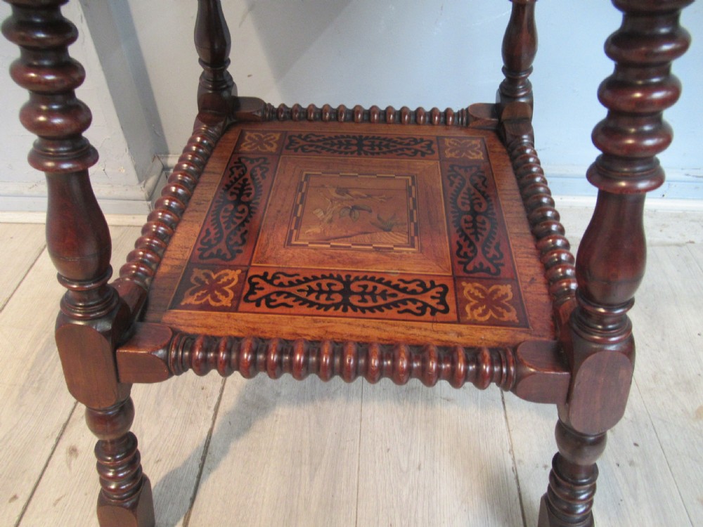 A 19th-century rich brown wood side table featuring a single drawer with marquetry inlay, carved bead edging, turned legs, and an inlaid lower shelf. View VII