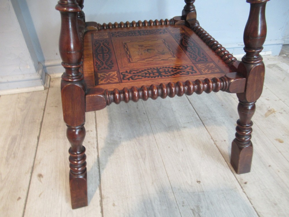 A 19th-century rich brown wood side table featuring a single drawer with marquetry inlay, carved bead edging, turned legs, and an inlaid lower shelf. View X