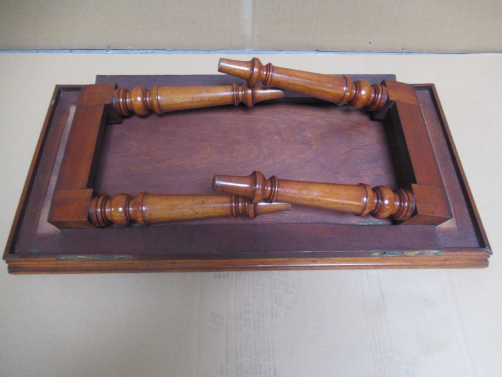 A low 19th-century mahogany folding campaign travel table featuring a tray top rim and turned legs. View III