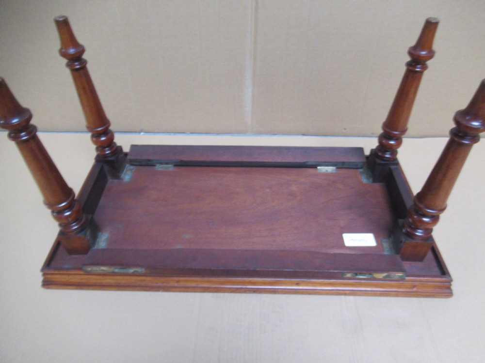 A low 19th-century mahogany folding campaign travel table featuring a tray top rim and turned legs. View VI