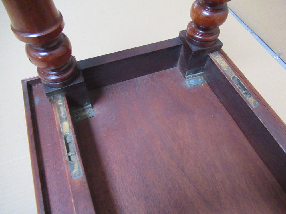 A low 19th-century mahogany folding campaign travel table featuring a tray top rim and turned legs. View VII