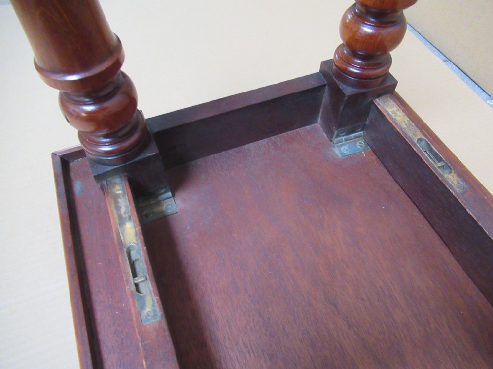A low 19th-century mahogany folding campaign travel table featuring a tray top rim and turned legs. View IX