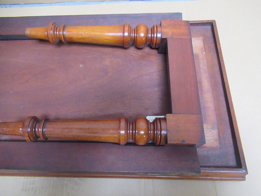 A low 19th-century mahogany folding campaign travel table featuring a tray top rim and turned legs. View XI