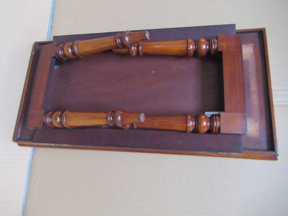 A low 19th-century mahogany folding campaign travel table featuring a tray top rim and turned legs. View XII
