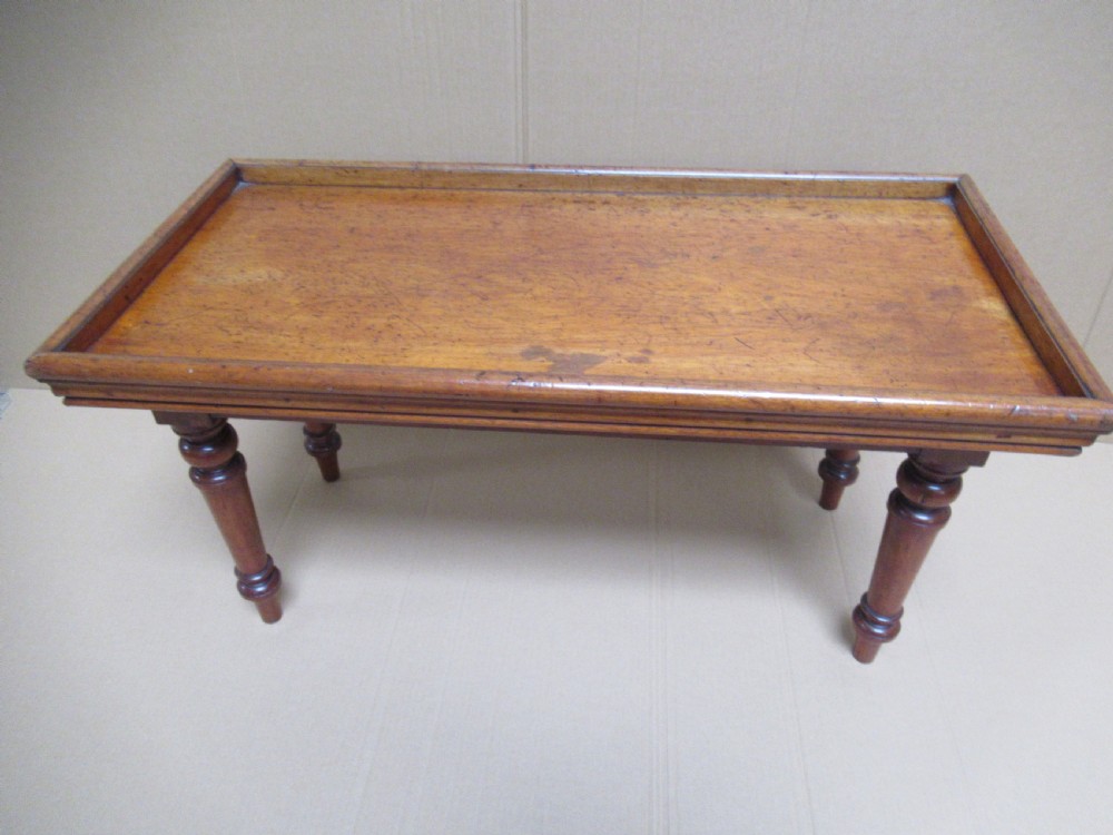 A low 19th-century mahogany folding campaign travel table featuring a tray top rim and turned legs. View XIII
