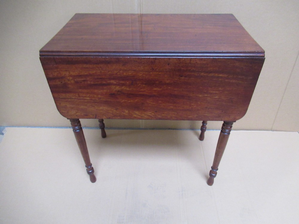A Victorian mahogany side table featuring a drop-front door revealing an internal compartment with slatted support and turned wooden legs. View II