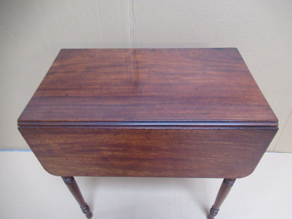 A Victorian mahogany side table featuring a drop-front door revealing an internal compartment with slatted support and turned wooden legs. View III