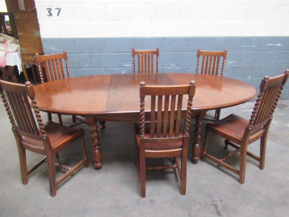 Oval oak extending dining table and set of six  dining chairs View II