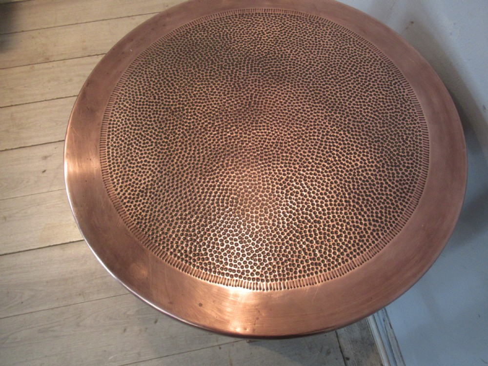A circular Arts and Crafts oak side table featuring a hammered copper top insert and stylized shaped legs with a lower cross shelf. View III