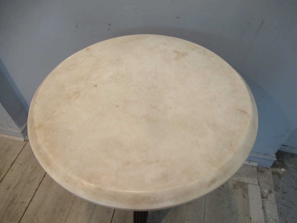A Regency period circular table featuring a white marble top supported by a reeded mahogany pedestal on a splayed tripod base with brass feet. View VIII