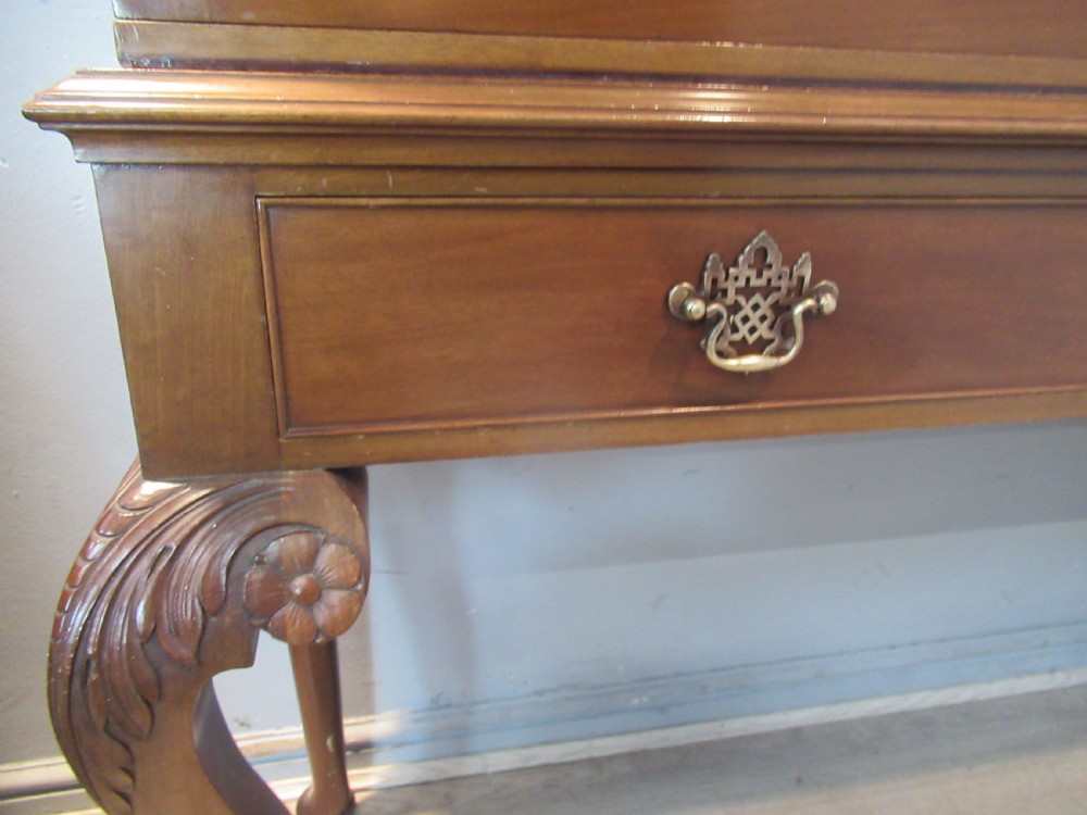 A Chippendale style mahogany glazed bookcase featuring geometric astragal doors, lower drawers, and carved cabriole legs ending in ball-and-claw feet. View VIII