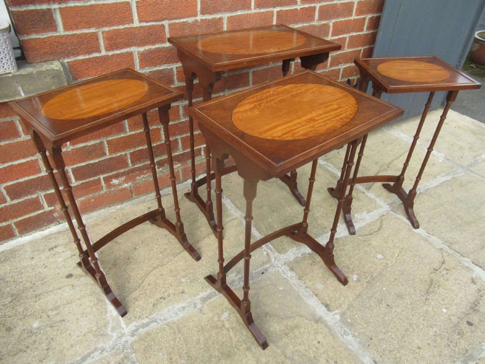 Nest of four mahogany and maple    side tables View V