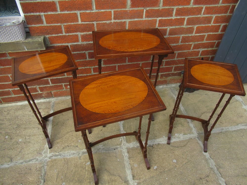 Nest of four mahogany and maple    side tables View VI