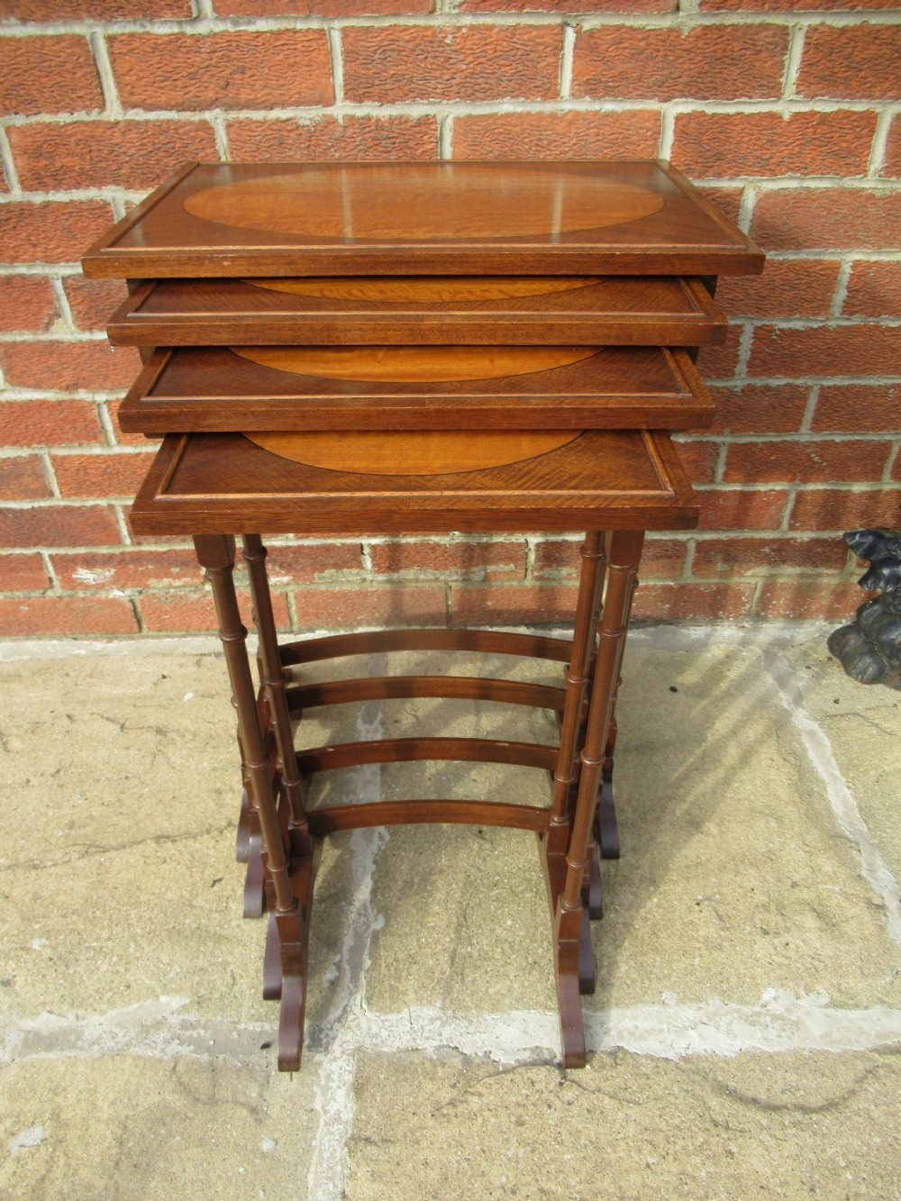 Nest of four mahogany and maple    side tables