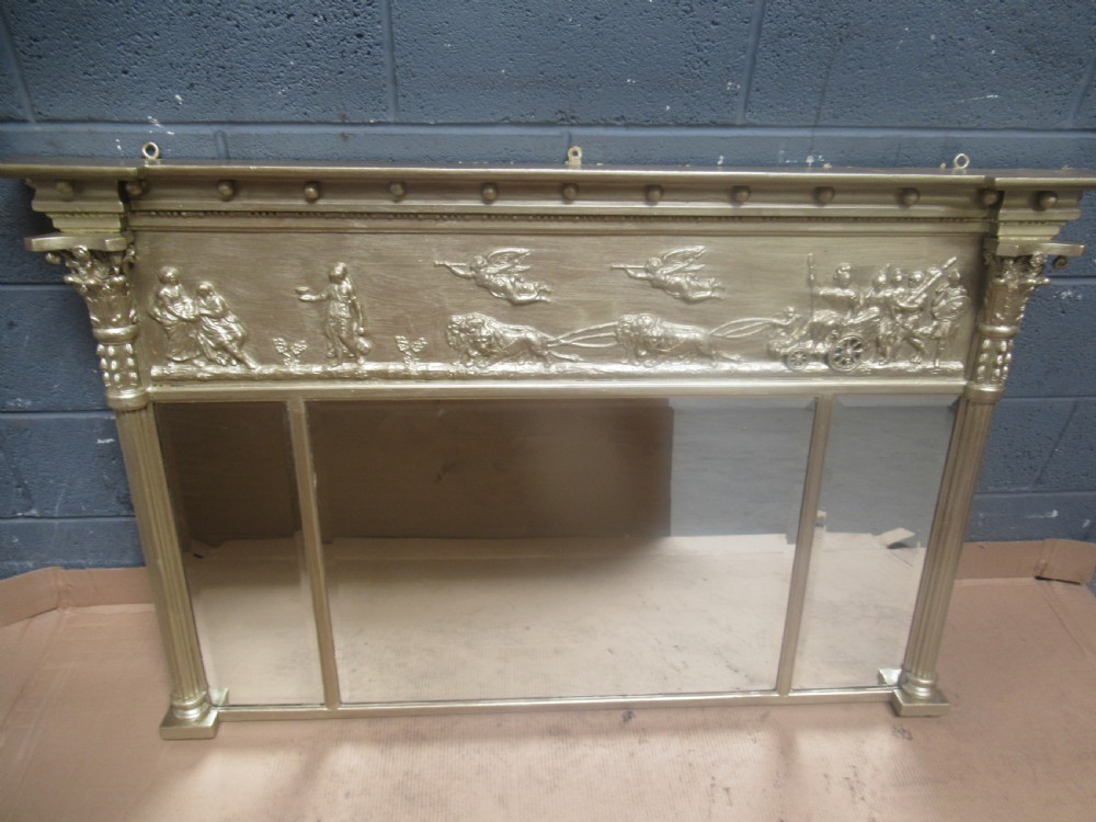 A 19th-century Regency gilt overmantel mirror featuring a detailed classical relief frieze, fluted side columns, and three glass mirror panels. View VII