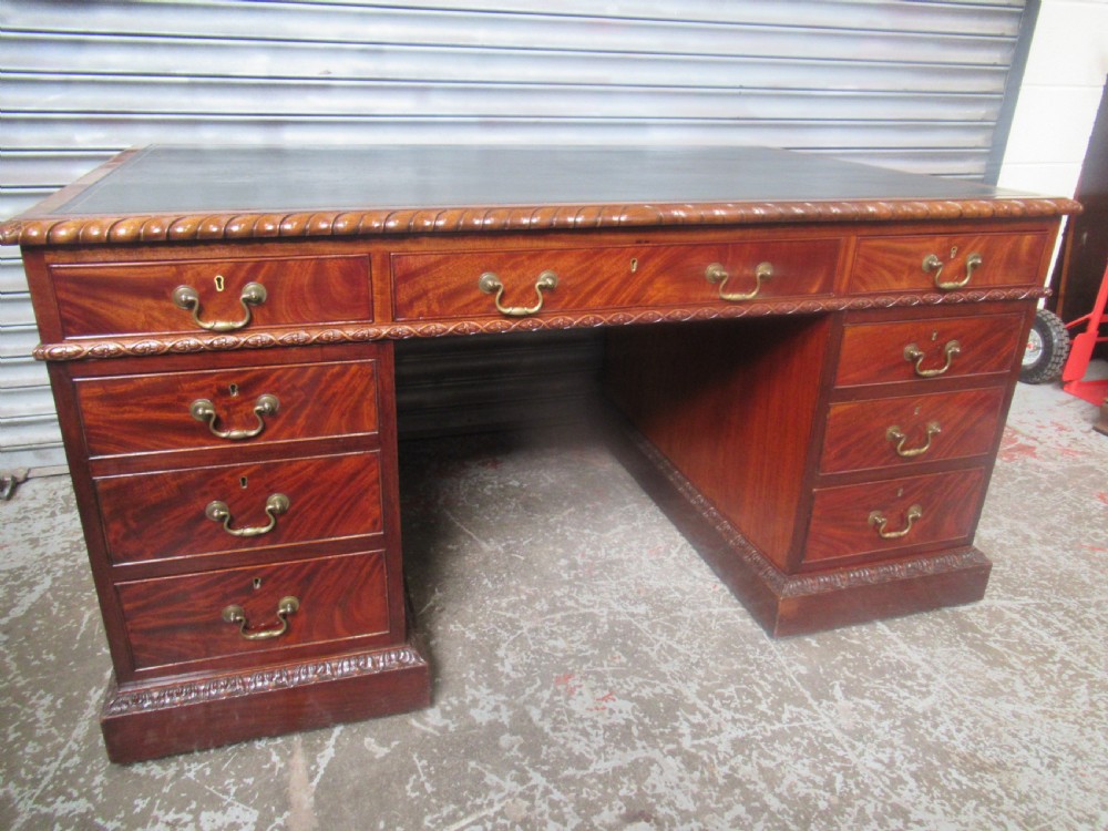 A large mahogany Georgian style pedestal desk featuring a dark green leather writing surface, brass swan-neck handles, and carved rope-twist moulding along the top edge. View II