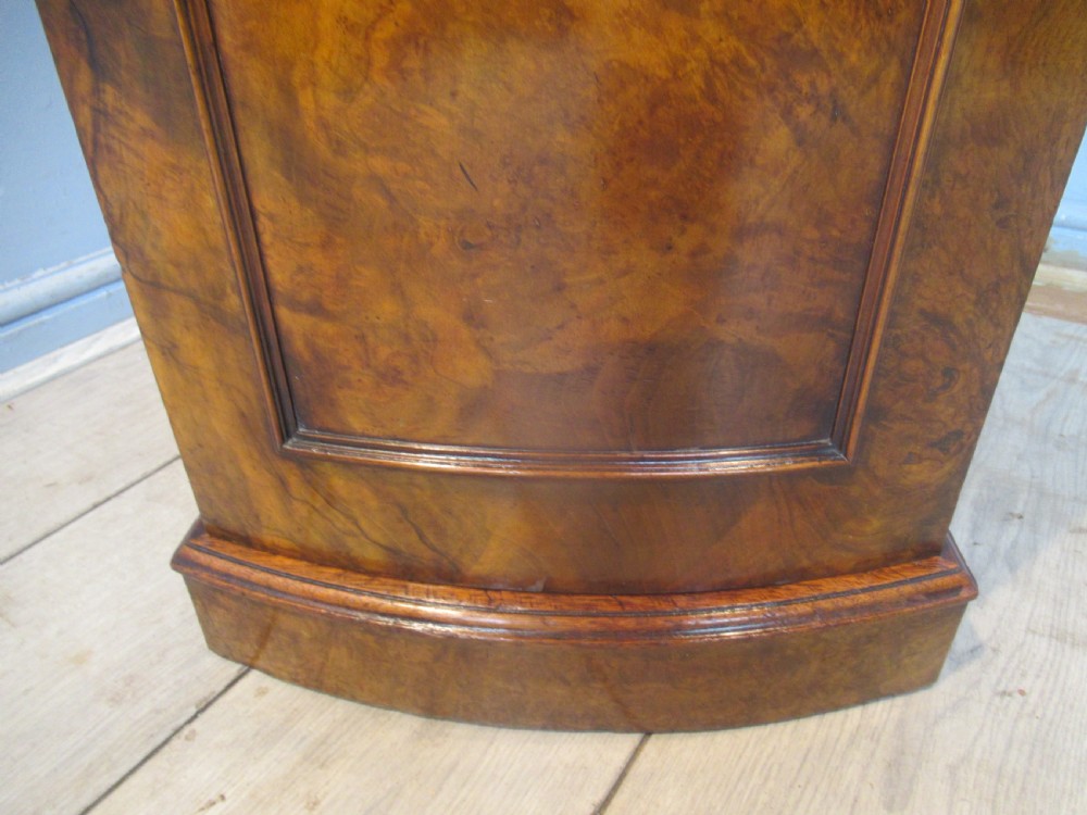 A Victorian burr walnut cabinet featuring a top drawer, a lower cupboard door with a carved shell motif, turned wooden knobs, and a shaped top upstand. View XII