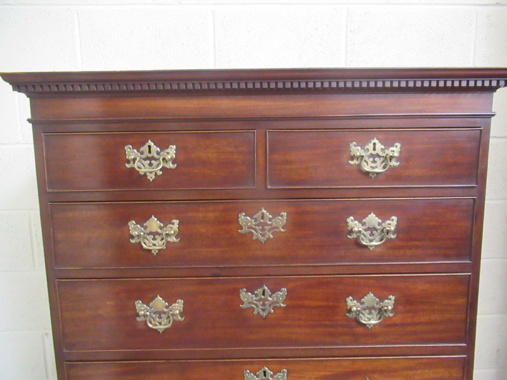 A late eighteenth-century Georgian mahogany tallboy chest on chest featuring a upper and lower section with brass handles and bracket feet. View VI