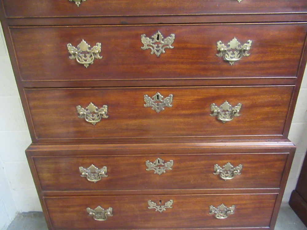 A late eighteenth-century Georgian mahogany tallboy chest on chest featuring a upper and lower section with brass handles and bracket feet. View VII