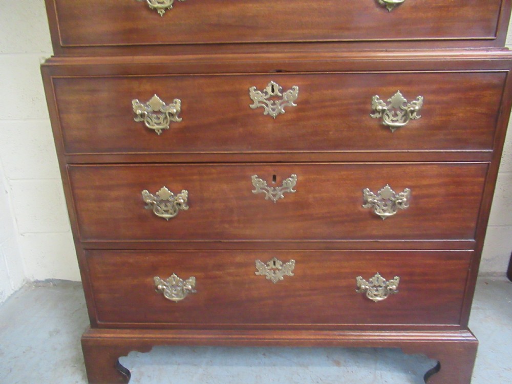 A late eighteenth-century Georgian mahogany tallboy chest on chest featuring a upper and lower section with brass handles and bracket feet. View VIII