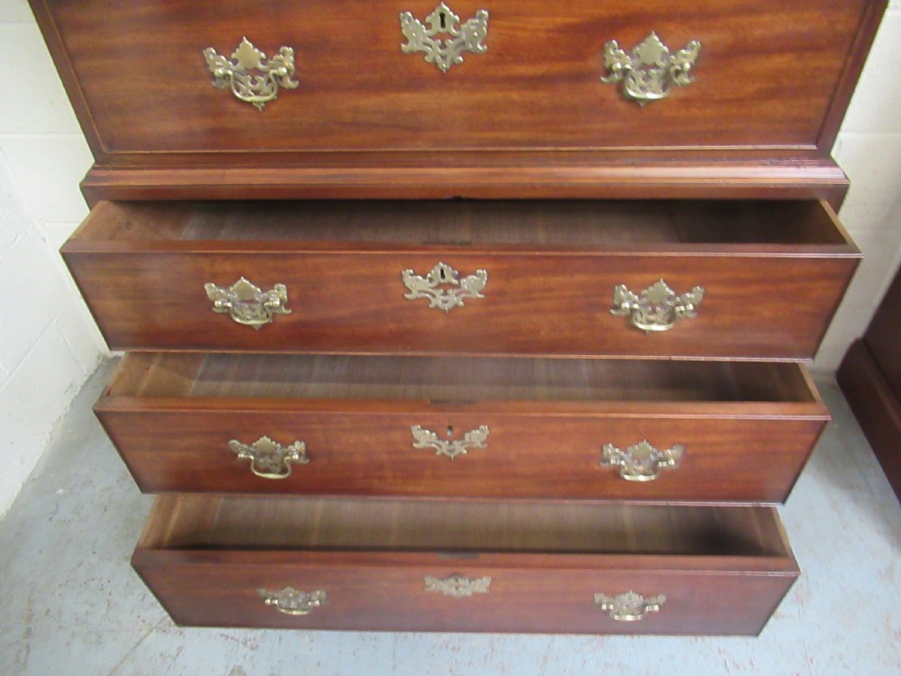 A late eighteenth-century Georgian mahogany tallboy chest on chest featuring a upper and lower section with brass handles and bracket feet. View IX