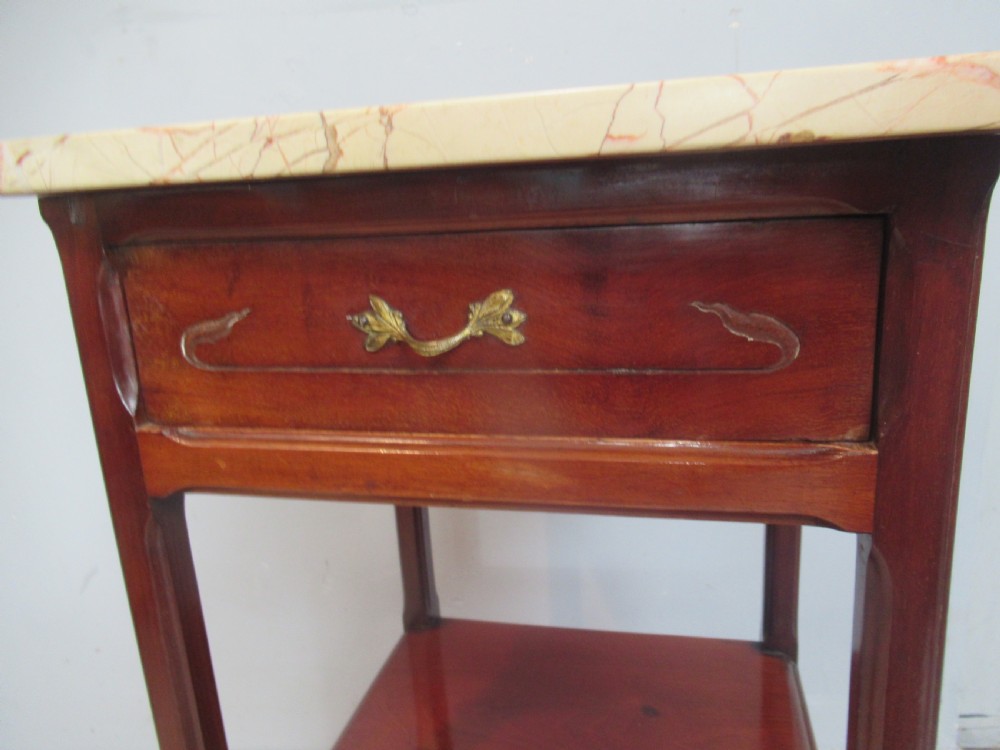 A tall reddish-brown mahogany side cabinet features a veined marble top, an upper drawer, an open central shelf, and a lower single door cupboard. View VI