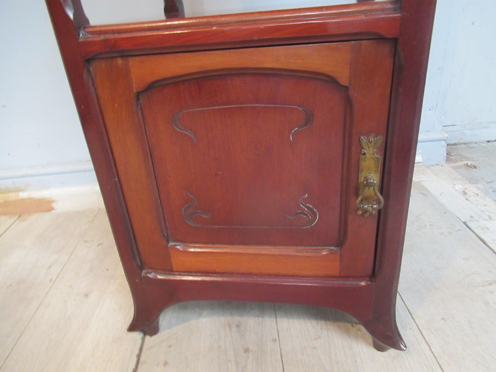 A tall reddish-brown mahogany side cabinet features a veined marble top, an upper drawer, an open central shelf, and a lower single door cupboard. View VII