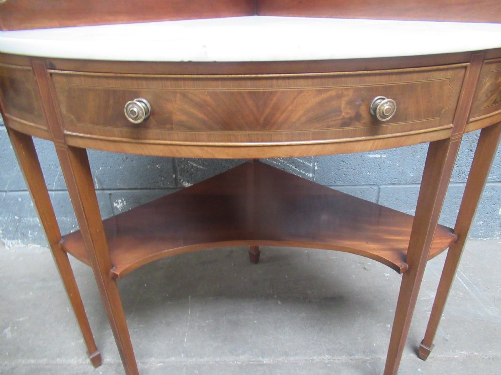 Edwardian mahogany   corner wash stand   with a marble   top. View II