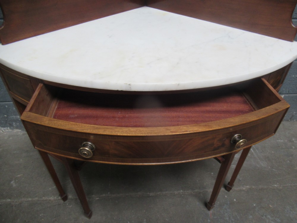 Edwardian mahogany   corner wash stand   with a marble   top. View V