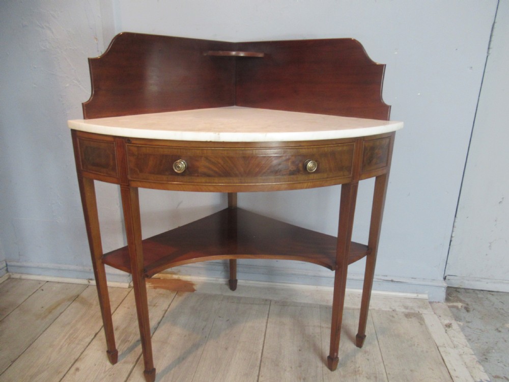 Edwardian mahogany   corner wash stand   with a marble   top. View VI