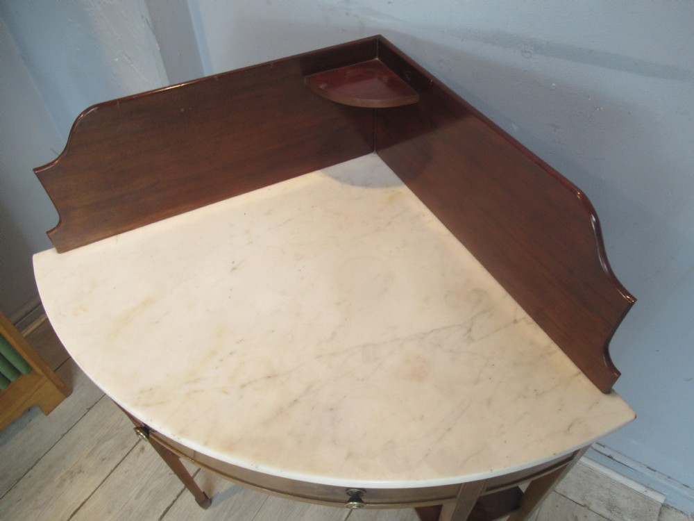Edwardian mahogany   corner wash stand   with a marble   top. View XI