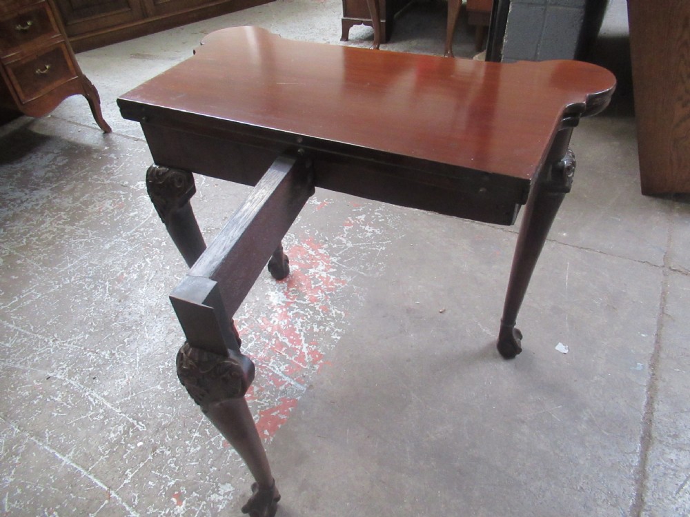 A Georgian mahogany fold-over card table featuring carved cabriole legs with acanthus knees and claw and ball feet. View IX